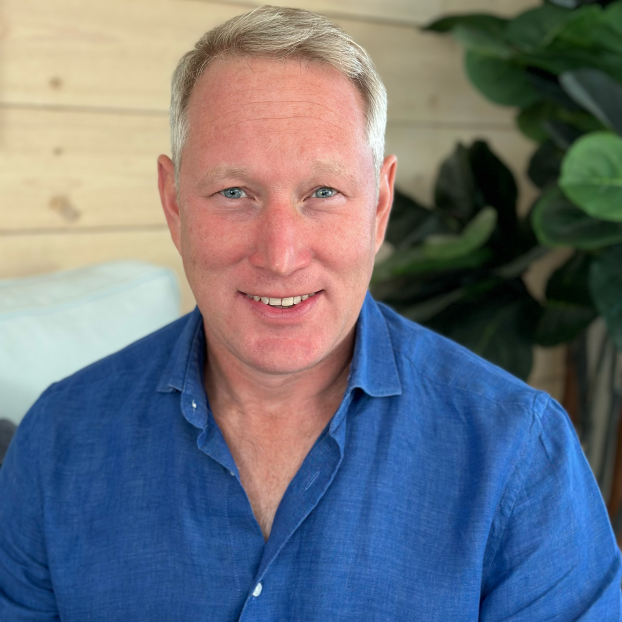 Tom Clark headshot in blue shirt